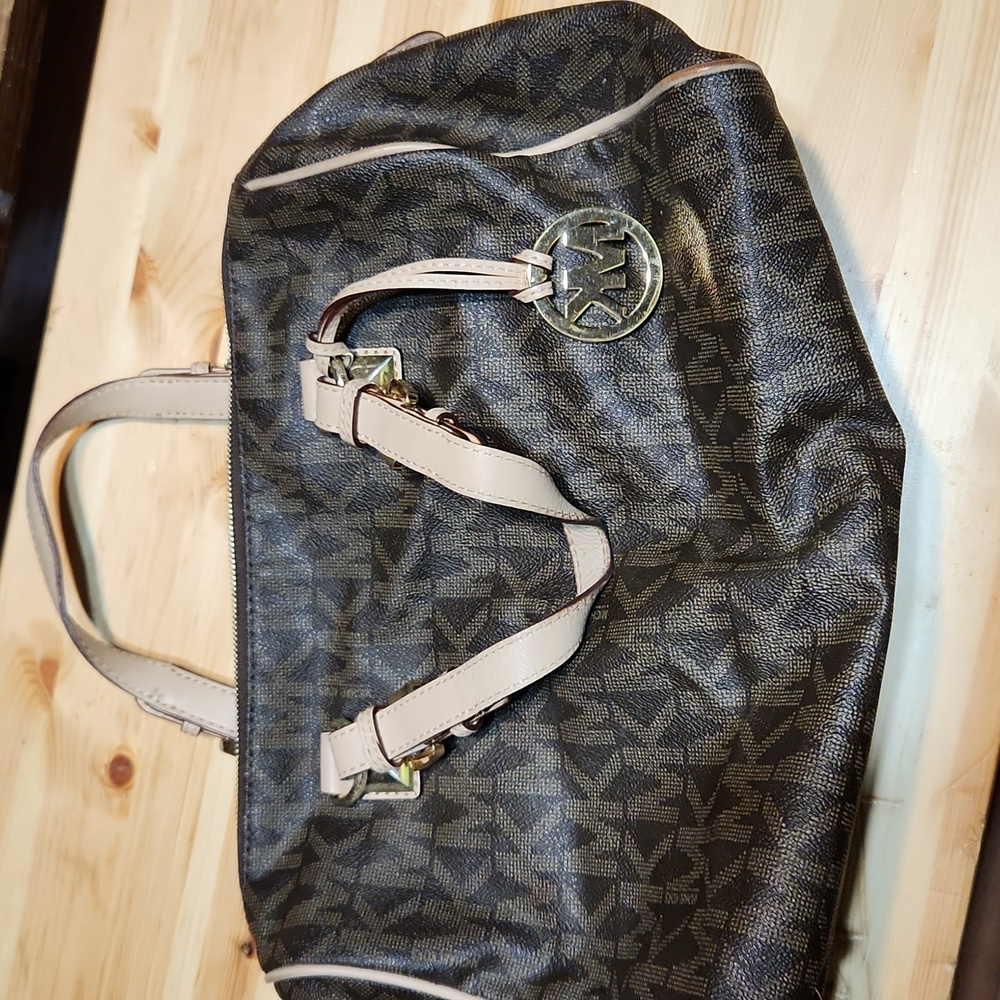 Michael kors purse brown and tan. Couple of red stains on inside liner.